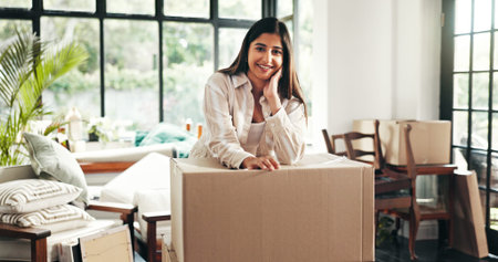 Portrait, smile and woman with box at new house for moving process, proud and investment as...