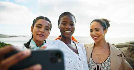 Women, friends and selfie with smile, beach and memory with diversity, vacation and post on web....