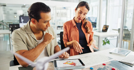 Energy, tablet and people with map in office for turbine location, power grid connectivity or planning. Sustainability, engineer or team with wind diagram for speed direction, frequency or innovationの写真素材