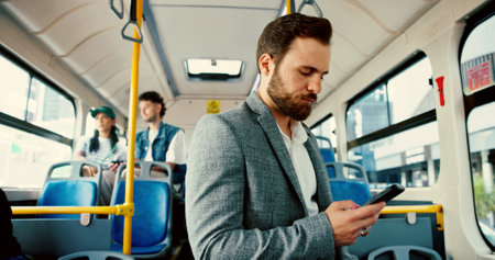 Businessman, phone and texting in bus, commute and check notification with mobile app, email and chat. Person, smartphone and contact on social network, web and travel with public transportationの写真素材