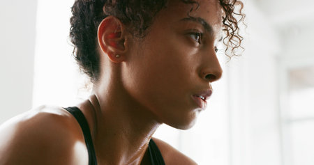 Sweat, fitness and face of woman tired for intense training, exercise and workout in morning. Sports, athlete and person with fatigue on break, resting and breathe for wellness, health and challengeの写真素材