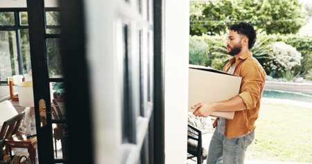 New house, buyer and man with boxes, real estate and ownership of property with mortgage or outdoor. Milestone, moving and person with cardboard for relocation, investment and purchase with home loanの写真素材
