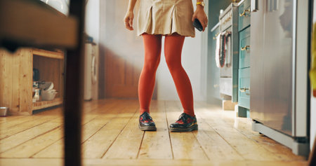 Dancing, fashion and shoes of woman in kitchen for casual, energy step and celebration. Legs, footwear style and dancer with feet of person and floor at home for trendy, chic and entertainmentの写真素材