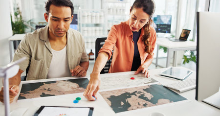 Energy, teamwork or people with map in office for wind farm layout, project planning or power development. Sustainability, engineer or pin marker for turbine location, site selection or data analysisの写真素材