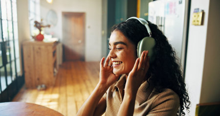 Headphones, happy and woman in home with remote work for creative magazine agency with project. Audio tech, relax and female critic editor streaming music, album or playlist for online review.の写真素材