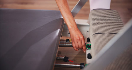 Fitness, pilates and hands of person with machine in class for exercise, practice and training....