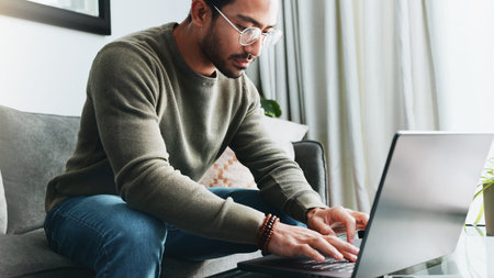 Glasses, online and laptop with man on sofa for freelancer, networking or email response. Reading,...