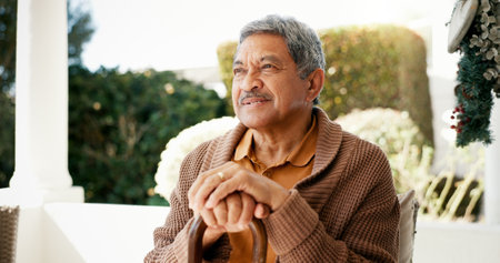 Thinking, elderly and man with disability at house of happy memory, nostalgia and past reflection. Smile, senior person and relax of lonely thoughts, retirement planning and remember life in backyardの写真素材