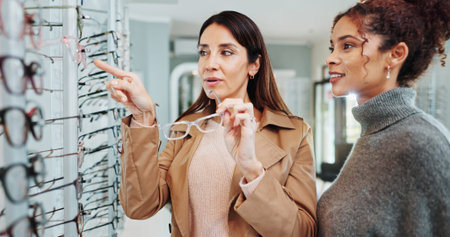 Eye care, woman and customer with glasses choice for optometry, prescription lens or pointing to...
