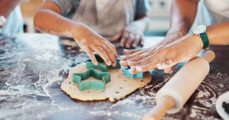 Hands, kitchen and child with parents, baking and helping kid with ingredients, bonding and together. Table, growth and development of fine motor skills for youth, people and cake for boy in homeの写真素材