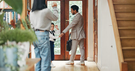Home, father and child with mother for goodbye, waving and student leaving to school with papa. House, mom and dad with girl going to kindergarten, education and learning with parents as familyの写真素材