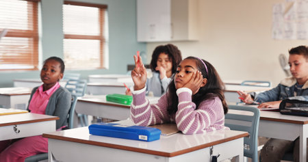 Girl, child and bored in classroom with education, tired or distracted for lesson with adhd at school. Pupil, fidget and kid with learning disability, daydream or thinking with scholarship at academyの写真素材