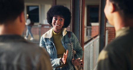 Friends, girl and talking in hallway at high school for learning break, campus gossip and education support. Teenager, gen z people and happy with conversation outdoor for scholarship and study tipsの写真素材