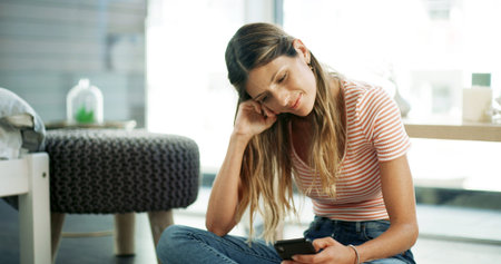 Woman, phone and smile on floor with relax, social media and funny message in text. Female person,...