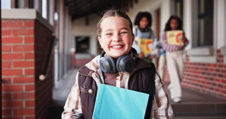Portrait, school and girl with book, smile and growth with education, child development and pride....