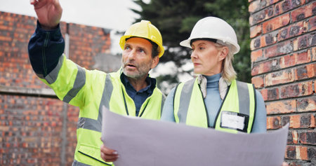 Blueprint, meeting and construction team on site planning for building, maintenance or repairs....