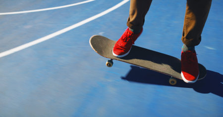 Skateboard, skill and person learning trick for outdoor hobby, activity or challenge at park. Sports, feet and legs of skater with sneakers for skating training for competition with freestyle in cityの写真素材