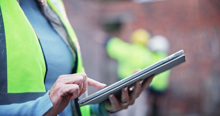 Hand, construction and woman on tablet at site for inspection, progress report and expansion safety....