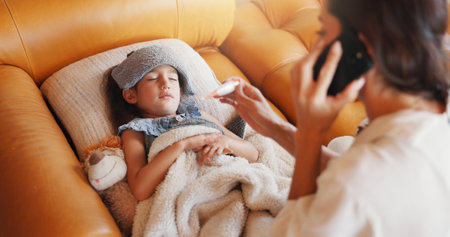 Phone call, sick and mother with girl, thermometer and disease with online consultation. Family, home or mama with daughter, smartphone or app for medical advice, telehealth or check fever with fluの写真素材