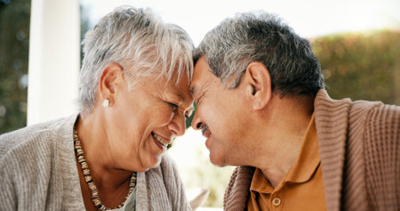 Outdoor, forehead and senior couple with love, relationship and bonding together with romance. People, old man and mature woman with marriage, care and retirement with support, relax and happinessの写真素材
