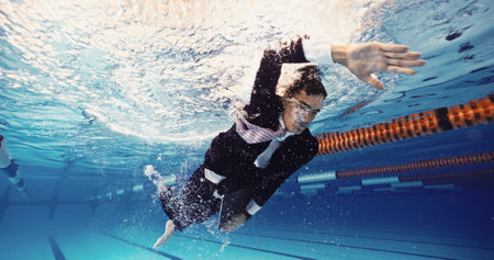 Swimming, water and businessman in pool, stress and drowning in company debt, laptop and corporate. Financial crisis, entrepreneur and worry for tax return deadline, workaholic and person underwaterの写真素材