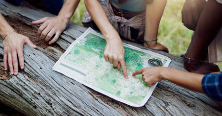 Map, nature and hands of people hiking in forest with route plan for adventure together. Travel,...