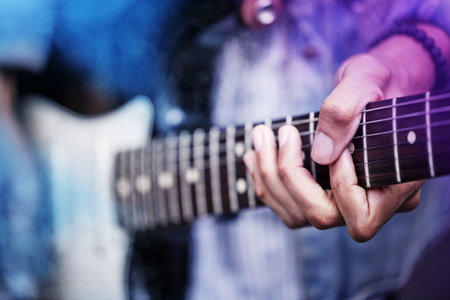 Man, guitar and hands for music performance, practice and talent rehearsal on acoustic instrument. Male person, recording studio and learning song or notes, artist and create melody or entertainmentの写真素材