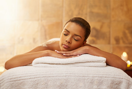 Woman, back massage and salt for treatment at spa, wellness and beauty therapy for body scrub. Female person, calm and skincare or dermatology, exfoliate and relax at resort hotel and peace for glowの写真素材