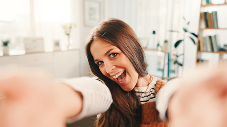 Excited, selfie and portrait of woman in home for relax, calm and break on weekend for social media. Happy, confident and female person with photography for profile picture in living room at house.の写真素材