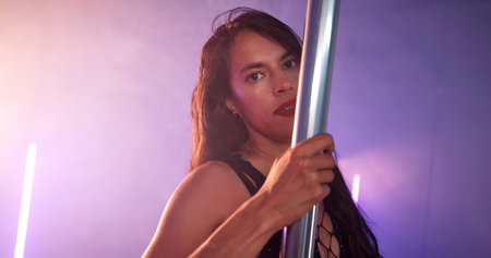Woman, portrait or dancer with pole for club, tease performance or sexy in night. Exotic, spotlight...