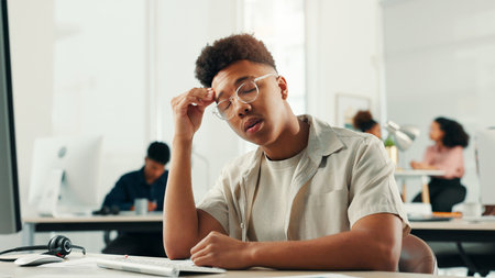 Computer, headache or stress with designer man in office for project or reporting deadline. Anxiety, burnout and frustration with small business employee in creative startup for problem solvingの写真素材