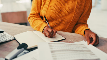 Writing, notebook and hands of business woman in office for administration, calendar and planning. Schedule, information and project reminder with closeup of employee for agenda and documentsの写真素材