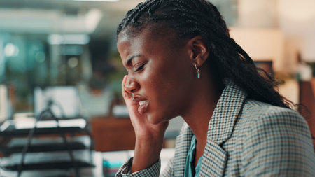 Business, black woman and pain of headache in office for submission deadline, article pressure and mental health. Media agency, journalist and migraine for brain fog, news story mistake or overworkedの写真素材