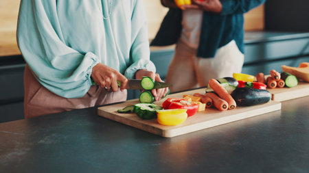 Hands, couple and cooking in kitchen with vegetables, knife and support with meal prep in home....