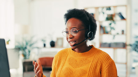 Home, black woman and laptop with headset for call center, consulting and telemarketing for freelancer. Remote work, female person and business agent with mic for customer service, sales and talkingの写真素材
