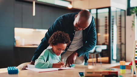 Black family, father and child with homework in home for school assignment, writing development and helping. Happy people, man or boy kid with book for creative lesson, education support and learningの写真素材