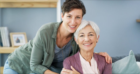 Hug, portrait and woman with senior mother on sofa for bonding, connection and family time. Happy,...