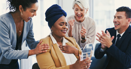 Business people, celebration and woman with award, prize and applause for recognition. Promotion, employees and consultant in workplace, KPI target and clapping with thank you, trophy and achievementの写真素材