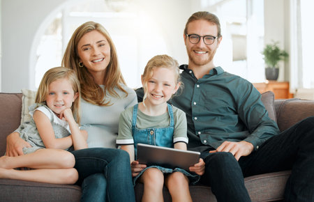 Portrait, smile and tablet with family on sofa in living room of home together for bonding....