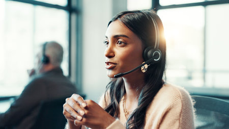 Telemarketing, woman and talking with microphone at call center for customer inquiry, product knowledge and FAQ. Consultant, employee and headset for online assistance, contact us or outbound callingの写真素材