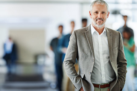 Smile, portrait and mature businessman in office with team for leadership, confident and positive...