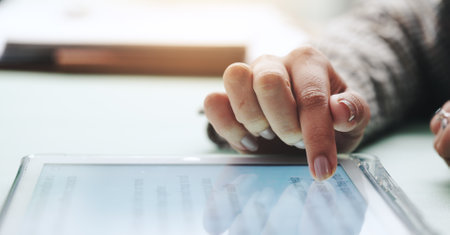 Hand, screen and businesswoman on tablet for news, finance or wealth management in office. Banker, feedback and financial advisor with internet for investment app, digital technology or online reportの写真素材