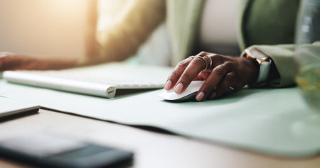Hands, mouse and business woman on computer in office for research, report and journalism on internet. Worker, keyboard and professional at desk for news article, creative story and email onlineの写真素材