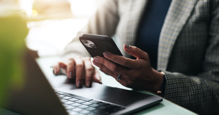 Hands, business and woman with laptop, cellphone and contact with creativity, communication and internet. Digital app, person or employee in workplace, pc or smartphone with seo or email for feedbackの写真素材
