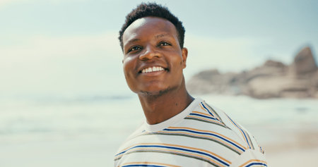 Thinking, smile and black man at beach for holiday, vacation or outdoor travel for adventure. Sea,...