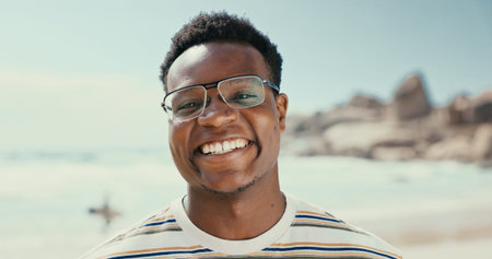 Portrait, smile and black man at beach for vacation, holiday and travel outdoor for adventure....