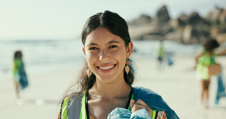 Happy woman, portrait or cleaning beach with recycling for eco friendly environment or earth day. Female person, activist or volunteer with smile for community service, save planet or world charityの写真素材