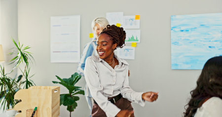 Business woman, celebration and dancing in office for success, promotion or profit with goals in finance job. Employee, dancer and winner with investing, growth or happy for achievement in workplaceの写真素材