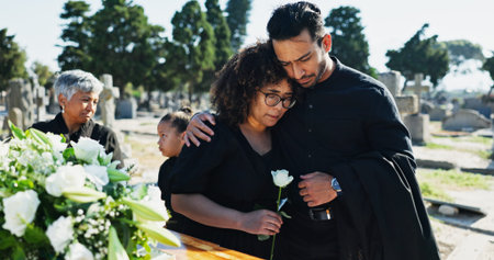 Hug, grief and funeral with people, graveyard or empathy with emotion, mental health or comfort....