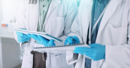 People, hands or scientist with tablet for research, new study or scientific data at laboratory. Closeup, science team or employee on technology for digital results, innovation or medical developmentの写真素材